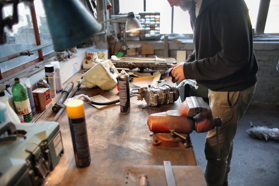 A skilled mechanic repairing machinery in a well-equipped workshop.