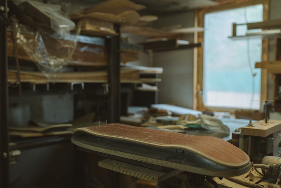 A glimpse into the detailed crafting process in a wooden skateboard workshop.